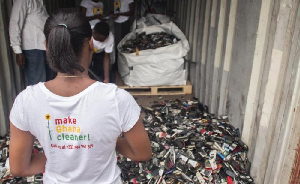 Woman looks at hundreds of old mobile phones