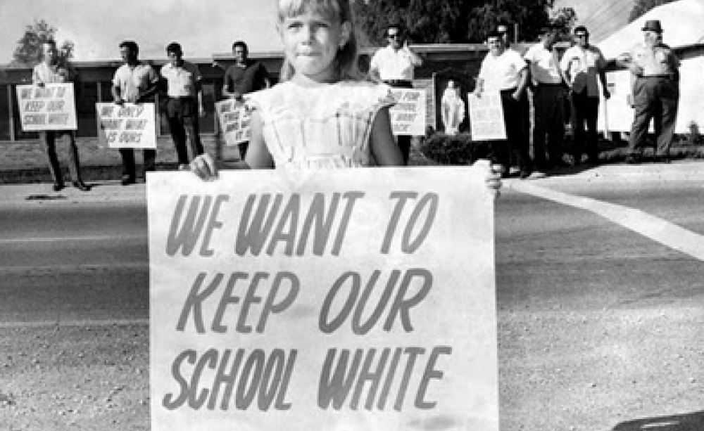 A white child protests desegregation of her elementary school in New Orleans, 1960 - "We Want To Keep Our School White"