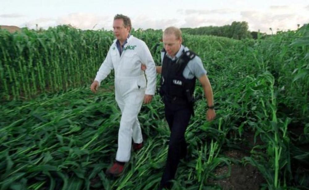 Peter Melchett being led away by a police officer at GM protest