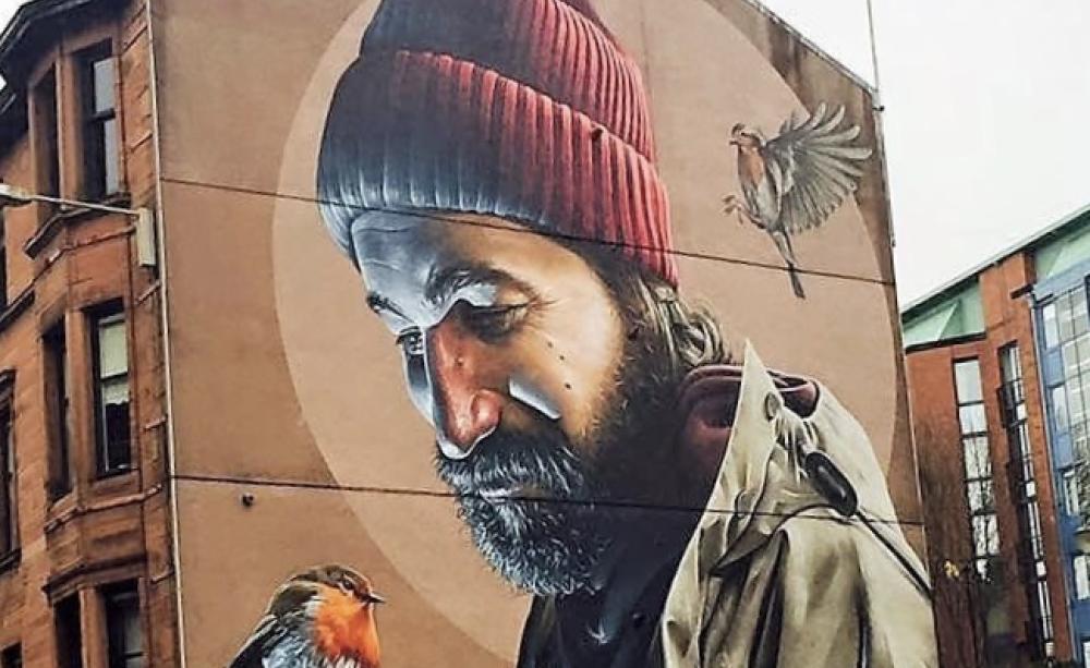 St Mungo of Glasgow with his totem Robin - artwork on the side of a building