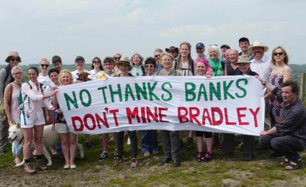 Protesters in countryside with banner saying 'No thanks Banks, don't mine Bradley'.