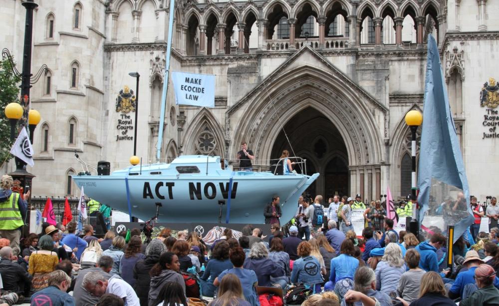 XR supporters wait outside the High Court to hear the judge's verdict