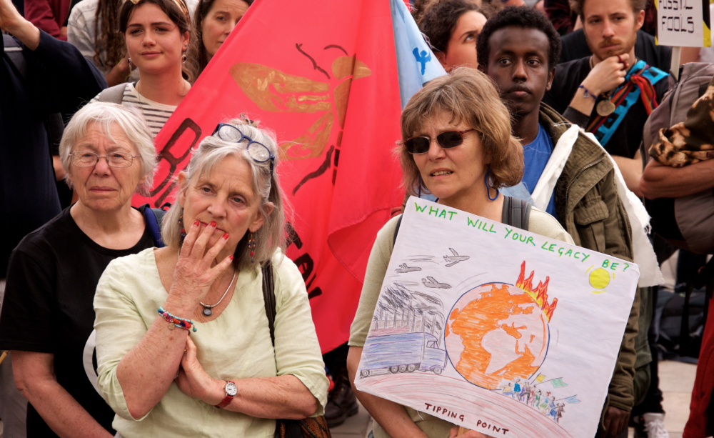 Climate protestors holding tipping point placard
