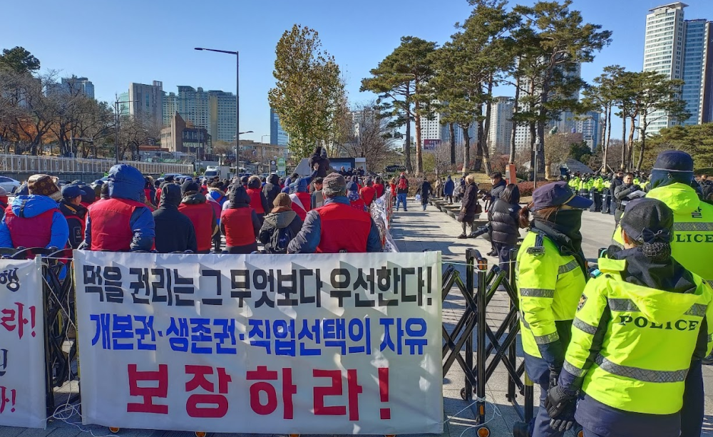South Korea dog meat farmers protest outside the presidential office in Seoul against plans to ban their trade. Banner reads "The right to eat comes before anything else! Guarantee fundamental rights, the right to survival, and freedom to choose occupation" A word play on "fundamental rights" translates as "dog fundamental rights," inadvertently highlighting the possibility that dogs have rights too.