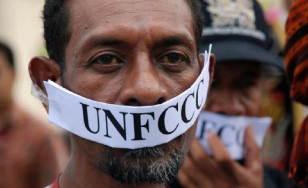 Gagged protester at COP19 in Warsaw. Photo: Langelle / GJEP-GFC.