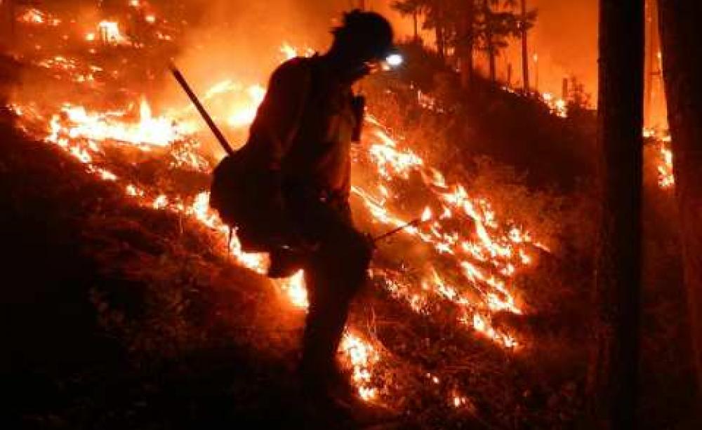 A Navajo Hotshot firefighter in Division A battles the West Mullan Fire in the Lolo National Forest, MT, July 2013. Photo: USDA via Flickr.com.