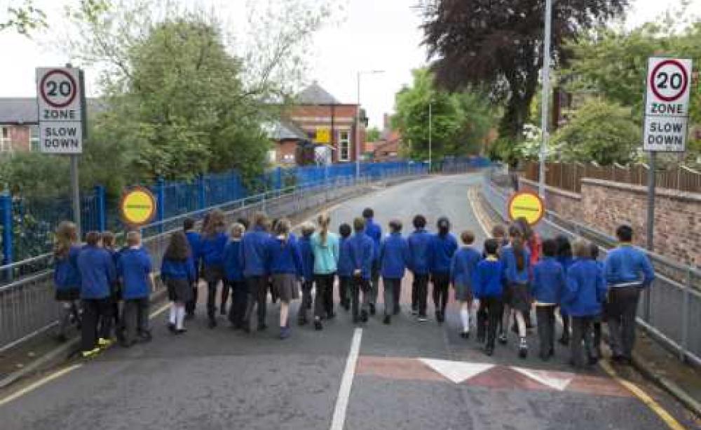 A class of 33 school children reclaiming a street near their school. The same number of child cyclists and pedestrians were killed on the roads in 2012. Photo: Bob Collier/PA Wire.