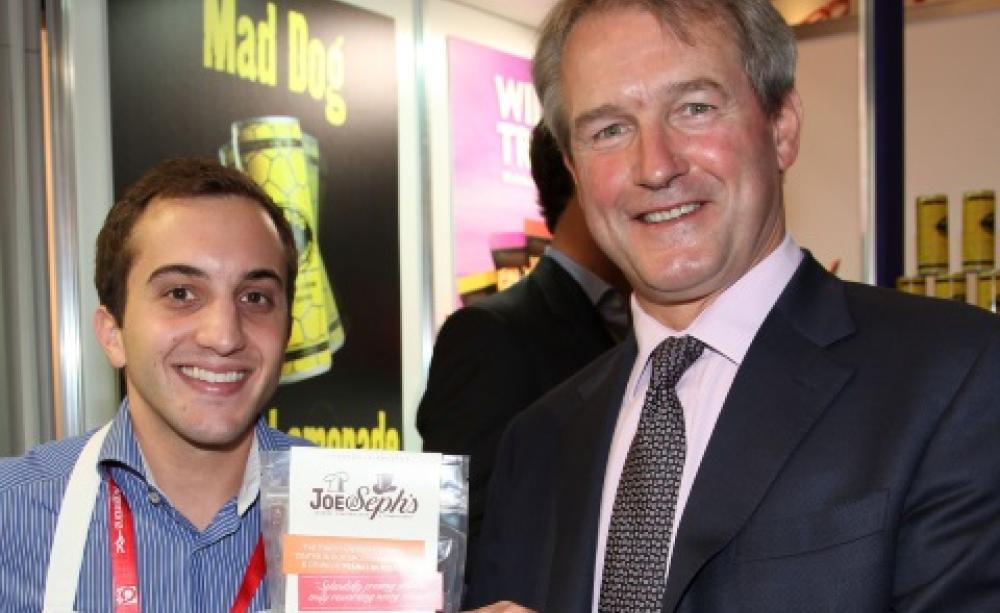 Owen Paterson MP with Joe &amp; Sephs Gourmet Popcorn. The 'Mad Dog' sign refers to a brand of lemonade. Photo: UKTI via Flickr.
