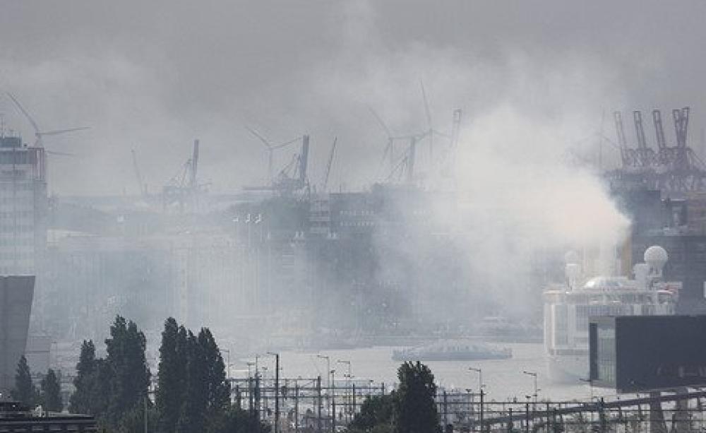 Amsterdam harbour: pollution like this costs lives and imposes health care costs of €900 bn per year across Europe. But is Juncker bothered? Photo: Erwyn van der Meer via Flickr.