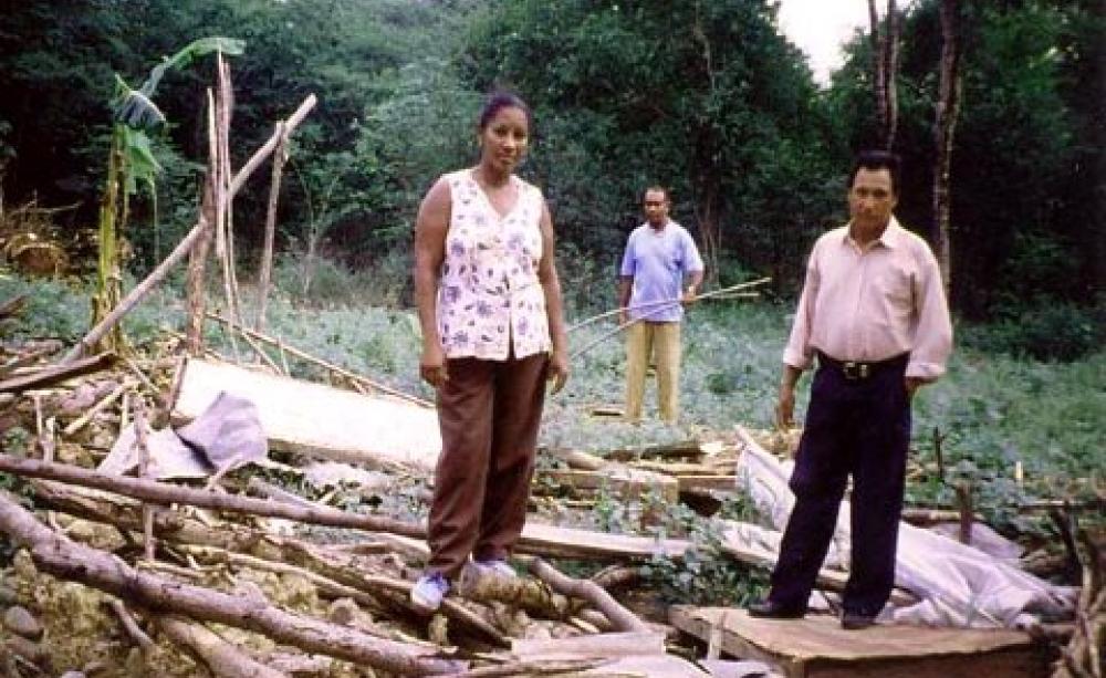 Villagers stand in the ruins of their house after the 2001 eviction of Tabaco. Photo: London Mining Network.