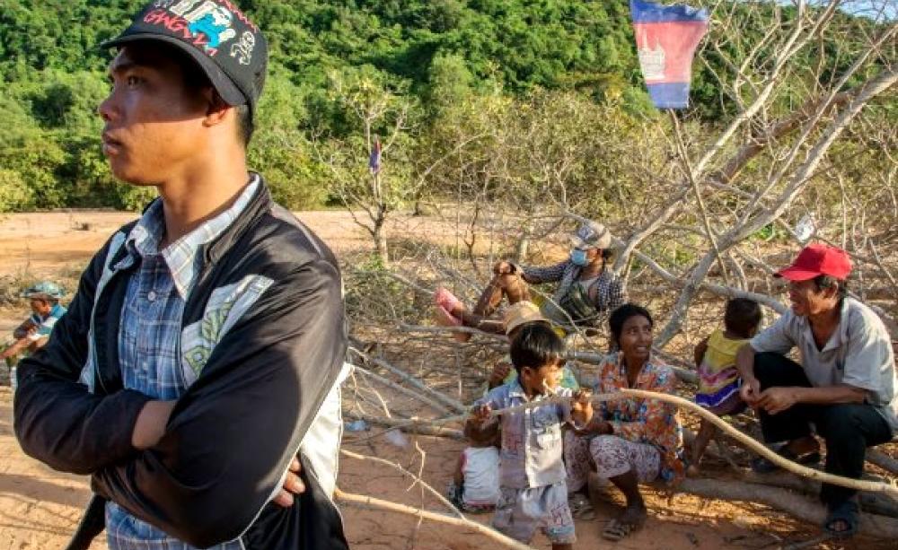 Residents of Prek Smach commune, Kiri Sakor district at a road block they have constructed out of trees and rocks. Botum Sakor national park, Koh Kon Province, Cambodia. Photo: Rod Harbinson.