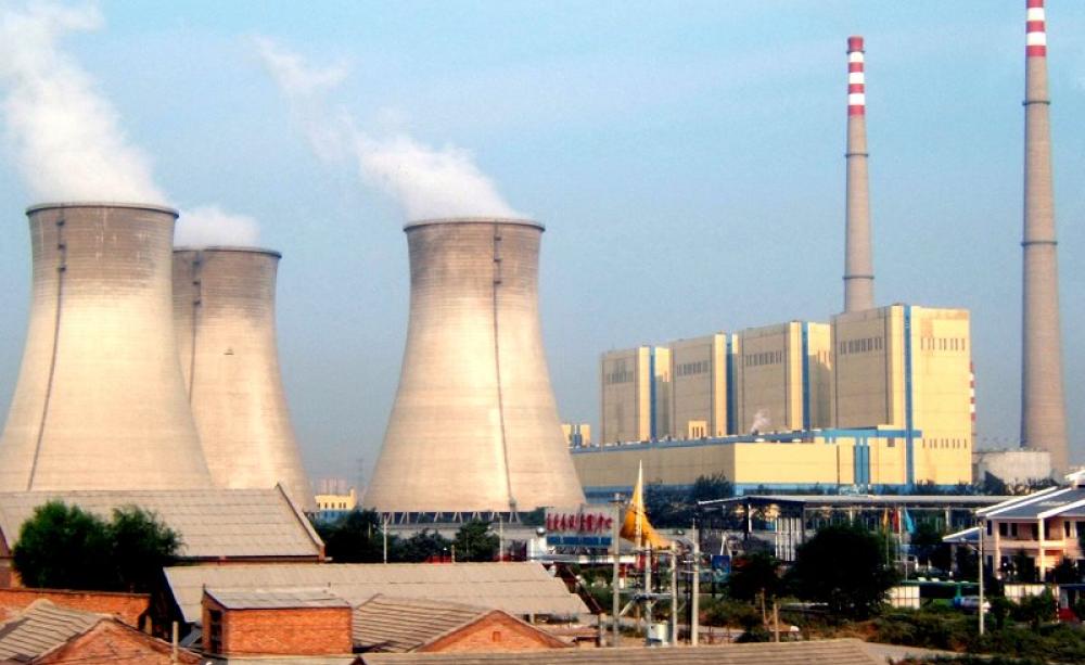 Despite constant reports of China's soaring coal burn, the country's carbon emissions are falling. Photo: coal power plant near one of Beijing's 'Ring Roads' by Bret Arnett via Flickr (CC BY-NC-SA).