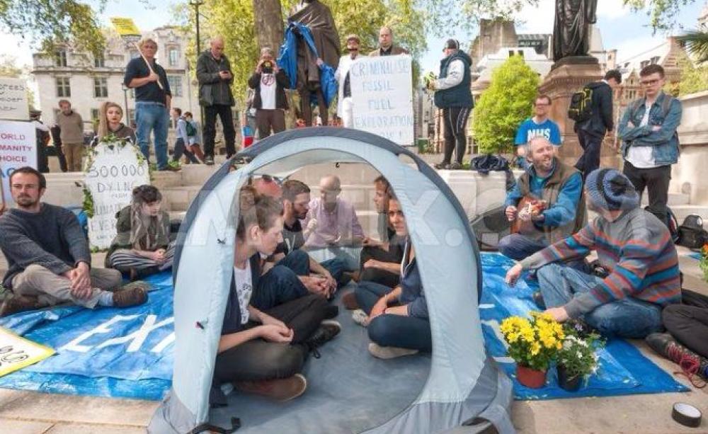 Donnachadh McCarthy is among those engaged in a peaceful 'sit in' protest in Parliament Square on Monday 4th of May at the foot of Mahatma Ghandi's statue, prior to his arrest. Photo: via Facebook.