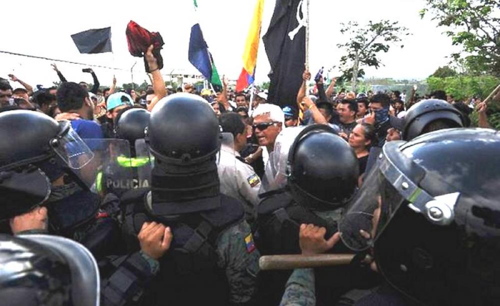 Ex-congressman Eduardo Veliz (white hair) leads a protest at San Cristobál airport, Galapagos, against excessive development, prior to his arrest. Photo: El Colono (Galapagos newspaper).