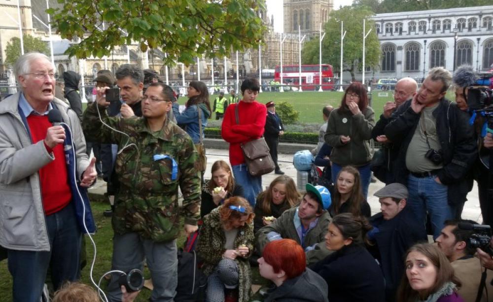Michael Meacher MP addresses the group 'The State We Need' at the Occupy Democracy protest in Parliament Square, 25th October 2014. Photo: Sheila via Flickr (CC BY-NC).