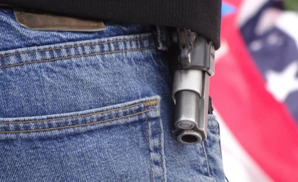 At a memorial for killed occupier LaVoy Finicum, guns were openly displayed. Photo: Peter Walker.