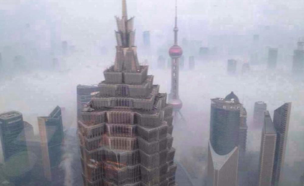 The costs of 'growth': Shanghai skyscrapers barely breaking the all-engulfing smog layer. Photo: erhard.renz via Flickr (CC BY).