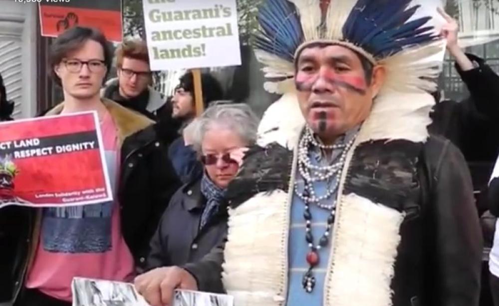 Guarani tribal leader and activist Ladio Veron speaking outside the Brazilian Embassy in London, in an action replicated across the globe. Photo: still from Survival video.