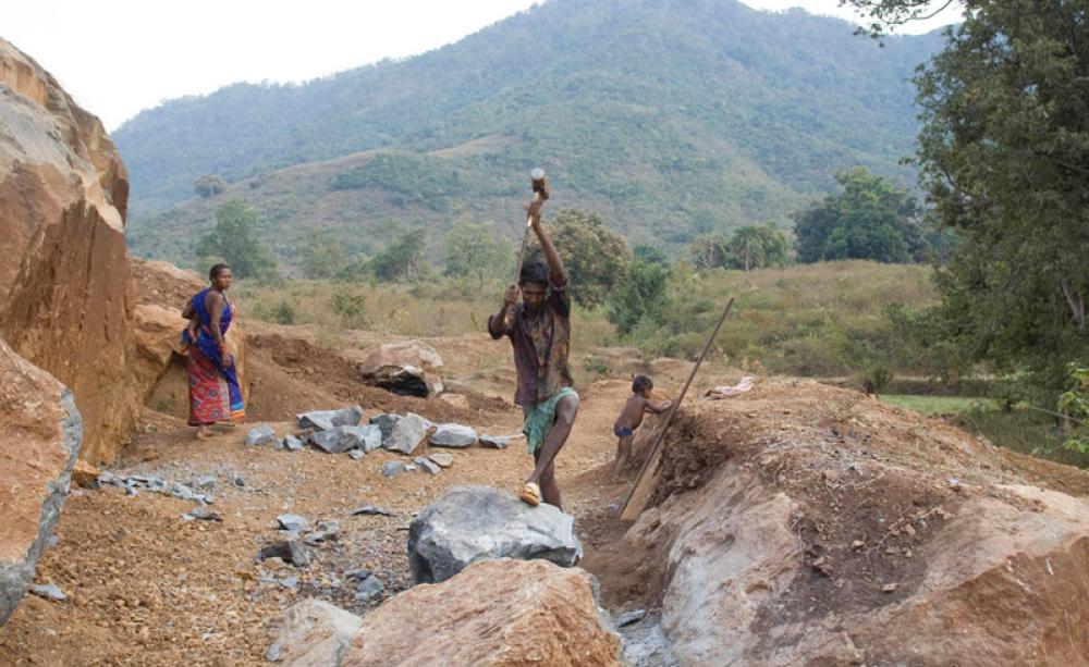 Labourers remove boulders from the landscape to make a road surface for the Vedanta plant in Lanjhigargh. In doing so they are causing irrepairable damage to the landscape. Stuart Freedman/ActionAid