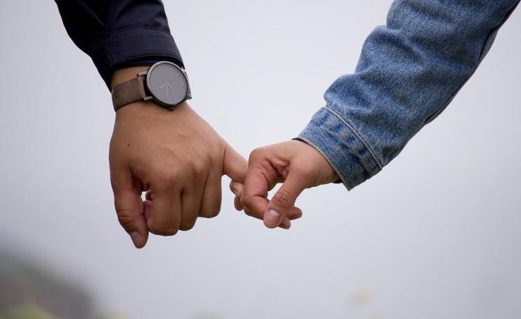Two people holding hands