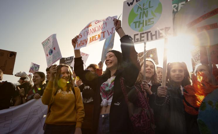 Student protesters holding placards at a Youth Strike for Climate demonstration