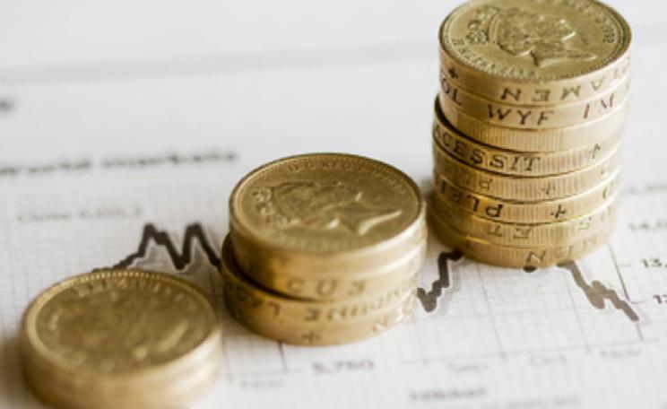 stacks of pound coins on a stock chart