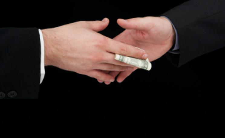 Cash passed between two hands