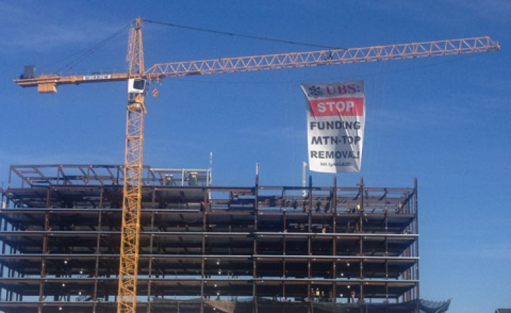 Protestors hang a giant banner to protest UBS's financing of mountain-top removal coal mining. Photo: Hands off Appalachia.