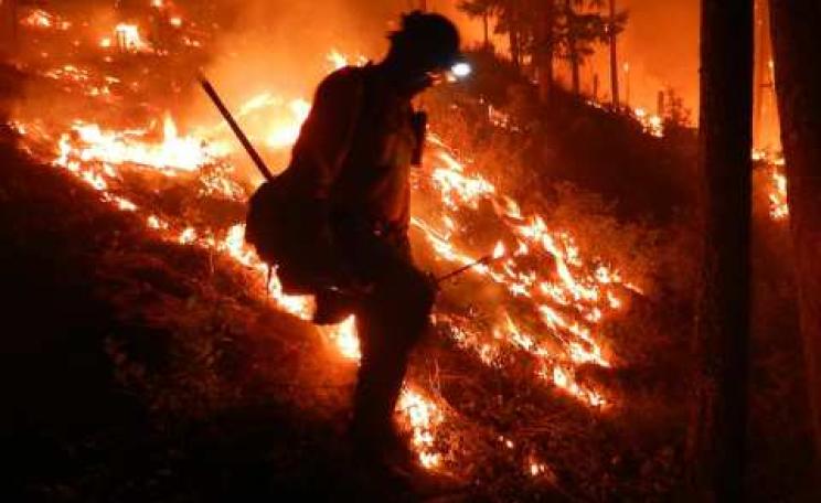 A Navajo Hotshot firefighter in Division A battles the West Mullan Fire in the Lolo National Forest, MT, July 2013. Photo: USDA via Flickr.com.