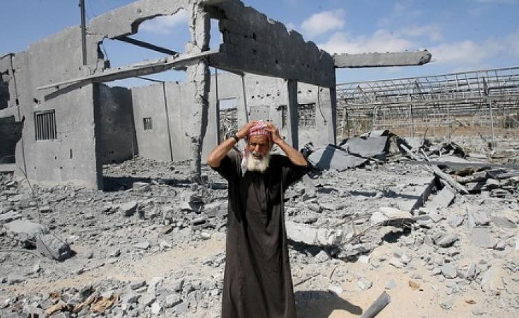 Could his loss be Israel's gain? A destroyed house in Gaza and its distraught owner, 22nd July 2014. Photo: Mohammed Al Baba / Oxfam International via Flickr.