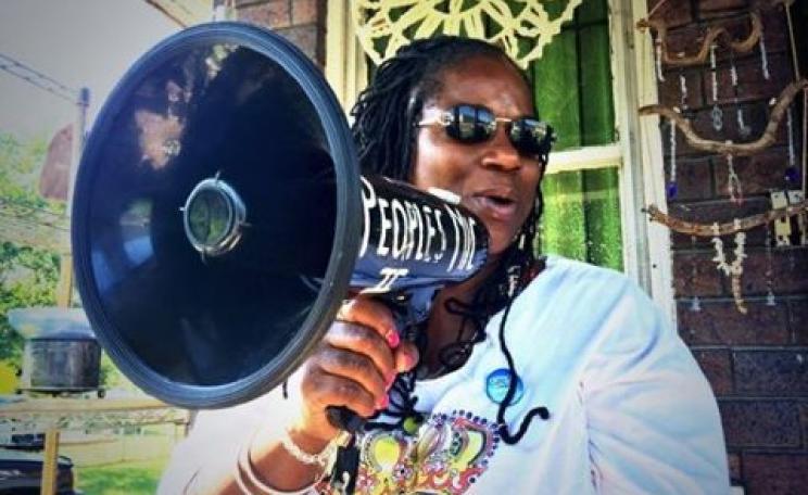 Shu takes to the megaphone to get her message across - water is a human right! Photo: Detroit Water Brigade via facebook.com/waterbrigade .