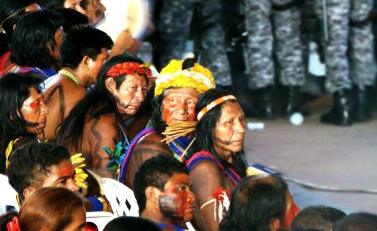 Indian tribes from the Xingu region protest at a Public Hearing for the Belo Monte dam in September 2009. Behind them stands a detachment from Brazil's National Security Force. Photo: J.Gil via Flickr (CC BY-NC-SA 2.0).