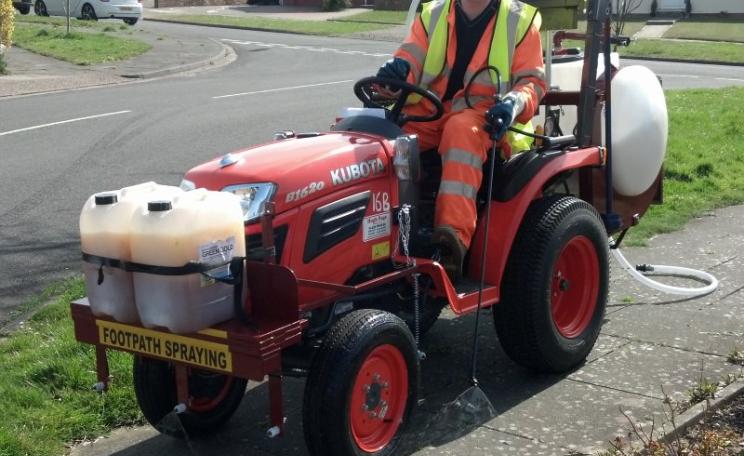 Herbicide being sprayed to keep a footpath in a residential area free of weeds. Photo: Nick Mole / PAN-UK.