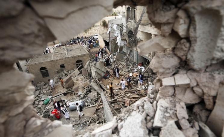 Yemenis stand on the rubble of houses destroyed in a suspected Saudi-led coalition air, via The Intercept.